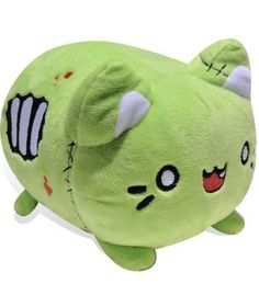 a green stuffed animal that is laying down