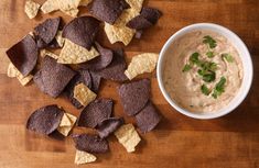 chips and dip in a white bowl on a wooden table