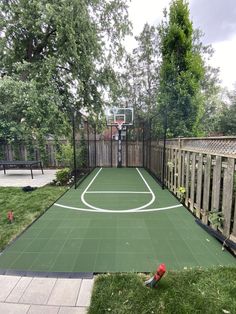 an outdoor basketball court in the backyard