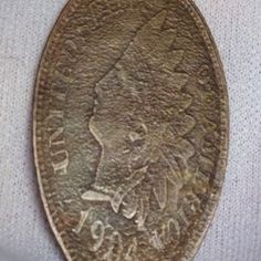 an old coin with a woman's face on it