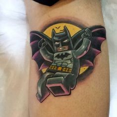 a batman tattoo on the leg of a man