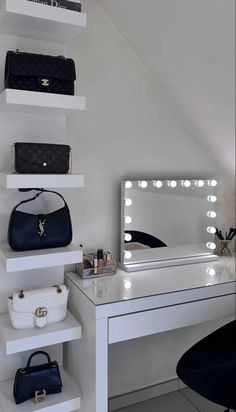 a white desk topped with a mirror and lots of purses on top of it