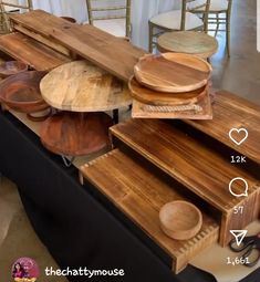 several wooden plates stacked on top of each other in front of tables with chairs around them