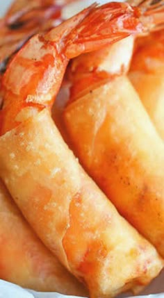 some food that is sitting in a paper plate on a table with chopsticks