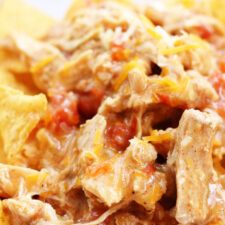 nachos with meat, cheese and salsa on top