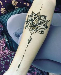 a woman's arm with a tattoo on it and a flower in the middle