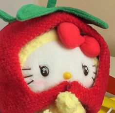 a hello kitty strawberry stuffed animal is shown