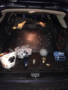 the trunk of a car with toys in it