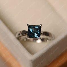 This ring features a 6*6 mm princess cut London blue topaz. Customization is available. It is made by hand, and it will take about 7 days to finish the ring after your payment is completed. Main stone: 6*6mm princess cut London blue topaz Main stone weight:1.30ct Metal type: sterling silver finished with rhodium/14k gold Accent stone: none Customization is available, I also can make it with 14k solid gold (white or yellow or rose) and diamond accent stone, just feel free to contact me. Any quest Silver Solitaire Engagement Ring, Ring Princess Cut, Memorial Ring, London Blue Topaz Ring, Princess Cut Rings, Blue Band, Gold Accent, Cz Diamond, London Blue Topaz