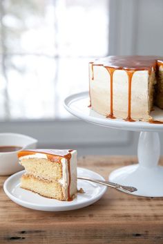 a cake with caramel drizzled on it sitting on a white plate