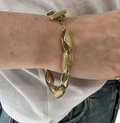 This is a 18k yellow gold bracelet featuring Crownwork® links similarly shaped to that of conch shells, with a diamond set toggle in a high polish finish. The conch shell links add a different dimension to the wrist which makes this bracelet a fun wear. All of our link bracelets have a Diamond set toggle clasp, its a personal little Ray touch that really gives it a chic and elegant look.This beauty gives a heavy gold look but is effortlessly lightweight and will sure be a conversation starter. The Crownwork® links allows for this bracelet to be dressed up or down. Wear this bracelet alone, or stacked up for some more volume. This bracelet comes standard measuring at 8" but we can adjust the length as needed based on personal preference by adding or removing links- message us for more detai Oval Link Bracelets With Clasp, Luxury Oval Link Bracelet With Toggle Clasp, Conch Shells, European Jewelry, Shell Bracelet, Sapphire Pendant, Conch Shell, Gold Stone, Shell Necklace