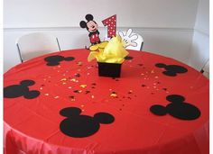 a red table topped with a mickey mouse centerpiece