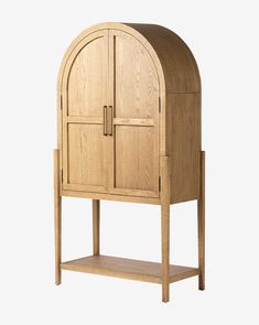 a wooden cabinet with an arched door and shelf on the bottom, against a white background