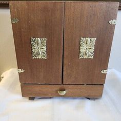 an old wooden cabinet with metal handles