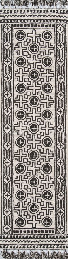 a black and white rug with fringes on it