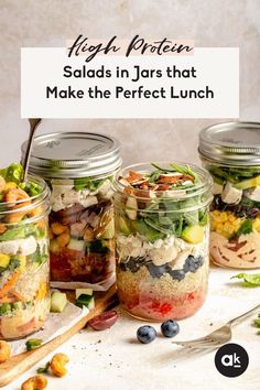 four mason jars filled with salads and vegetables