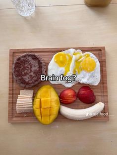 a wooden tray topped with food on top of a table