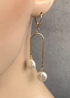 Shop Arch Earrings Gold. Real pearl earrings will add a perfect touch of flair to your outfit! These modern pearls drop earrings are made from: - 18K Gold plated connectors - White freshwater coin pearls - about 10mm-it can be small variations - Gold Filled ear wires-French hook Freshwater pearls are slightly different in size, so it makes every pair unique. Modern statement earrings u shaped are 2 7/8 inches long and light. Bohemian Jewelry will make a great gift! Your order will be mailed with White Dangle Pearl Clip-on Earrings, White Dangle Clip-on Pearl Earrings, White Pearl Dangle Clip-on Earrings, Elegant Adjustable Dangle Clip-on Earrings, Adjustable Long Drop Wedding Earrings, Pearl Drop Dangle Clip-on Earrings As Gift, Pearl Drop Dangle Clip-on Earrings For Gift, Clip-on Dangle Earrings With Pearl Drop For Gift, Adjustable Dangle Pearl Earrings