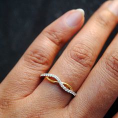 "Crafted in 14k solid gold, this simple ring has gorgeous curves in the right places ;) Shaped like infinity for your infinite love and respect for the receiver! * Diamond Wt. : 0.20 Cts (approx) * Color-Clarity Grade : H-I, Vs-Si * Gold - 14kt, 1.5 gms solid yellow gold (approx) If you like this ring, please press \"Pin it\" button on the right of your screen. Find us on Instagram for exquisite designs: @abhikajewels Like us on Facebook: www.facebook.com/Abhikajewels Thank you for visiting our Elegant 14k Gold Diamond Infinity Ring, Elegant Infinity 14k Gold Diamond Ring, Modern Twist Infinity Stackable Rings For Anniversary, Elegant Infinity Rings With Half Eternity Detail, Elegant Infinity Half Eternity Rings, Elegant Half Eternity Infinity Rings, Anniversary Infinity Stackable Rings, 14k Gold Infinity Diamond Promise Ring, Elegant Gold Infinity Stackable Rings