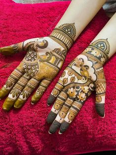 two hands with henna designs on them