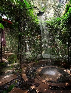 an outdoor shower in the middle of some trees