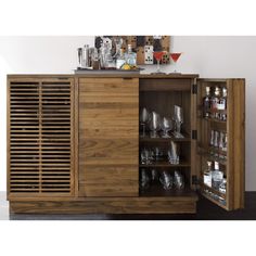 a wooden cabinet filled with lots of glasses