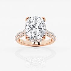 a rose gold engagement ring with an oval cut diamond surrounded by pave set diamonds