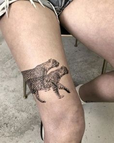 a woman's leg with a tattoo of a cheetah on it