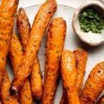 some fried carrots on a plate with dipping sauce