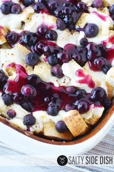 a blueberry cheesecake in a white dish on top of a wooden table with the title above it