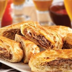 several pastries on a plate with drinks in the background