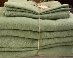 a pile of green towels sitting on top of each other