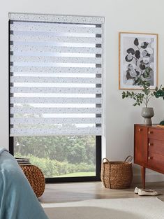 a bedroom with a bed, dresser and window covered in blind shades on the windowsill