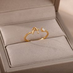 So simple and gentle our Tiny Boho Initial Letter Rings will reveal your dreamy romantic nature. You can wear those rings stacked with a wedding ring to bring that exceptional meaning to your total look. Also, Tiny Boho Initial Letter Rings are a great gift for any occasion since their design fits any style and finger size. Description Material: Stainless steel. Surface Width: 2mm Colors available: gold, rose gold, silver. Inclusions: Cubic Zirconia Avoid wearing jewelry while showering, sleepin Gold Ring For Women Design, Stainless Ring Women, 1 Gm Gold Ring, Gold Ring Collection, Alphabet Rings Gold, Gold Ring Designs Unique For Women, S Letter Ring, Ring Designs Gold For Women, Ring Designs Silver