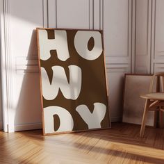 a brown and white sign sitting on top of a hard wood floor next to a chair