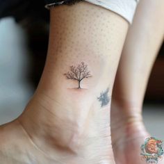 a small tree tattoo on the ankle