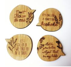 four wooden coasters with different sayings on them