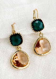 A pair of two-stone bezeled gem earrings in emerald and blush. Gold Faceted 14k Gold-filled Earrings, Gold Dangle Crystal Earrings With Gemstone Accents, Gold Crystal Earrings With Gemstone Accents As Gift, Jewellery Lookbook, Sparkling Engagement Rings, Black Dress Accessories, Lafayette Louisiana, Small Gold Hoop Earrings, Ideas For Jewelry