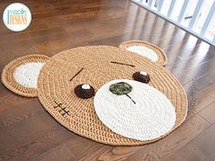 a crocheted teddy bear rug on the floor