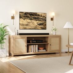 a living room scene with focus on the entertainment center and large screen television mounted to the wall