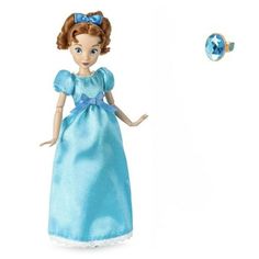 the doll is wearing a blue dress and has her hands out to catch a ball