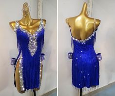 two mannequins dressed in blue dresses with sequins and beads on them