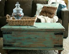 an old trunk is sitting on top of a coffee table in front of a couch