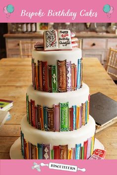 a three tiered cake made out of books on top of a wooden table in a kitchen