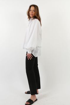 Infusing a full sleeve to the classic collared button-down, this lightweight poplin blouse features voluminous gathered sleeves, a traditional cuff, a flat back, and a relaxed, oversized body with a gentle high-low hem. The Sawyer Shirt is fabricated in our best-selling Premium Italian Cotton shirting that is crisp yet breathable, soft yet beautifully structured. Shirting that lasts a lifetime and is never transparent. Size Chart and Fit Jarbo US Bust Front Length Back Length OS US 2-16 62" 24 1 White Relaxed Fit Dress Shirt For Office, White Blouse With Relaxed Fit And Fold Down Collar, White Blouse With Fold Down Collar And Relaxed Fit, Full Sleeve Shirt, Poplin Blouse, Puff Sleeve Shirt, Gathered Sleeves, New Launch, High Low Hem