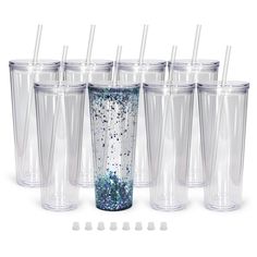 six clear tumblers with blue and silver glitters are lined up next to each other