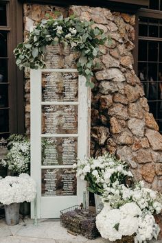 an old window is decorated with flowers and greenery for a wedding ceremony in italy