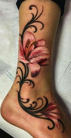 a woman's foot with a flower tattoo on it