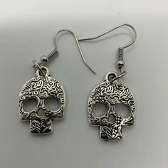 Day Of The Dead Skull Earrings Steel Stainless Small Gothic Skull Earrings For Halloween, Adjustable Gothic Skull Earrings, Bohemian Skull Earrings For Gifts, Punk Skull Print Earrings For Gift, Punk Skull Print Earrings Gift, Punk Style Skull Print Earrings As Gift, Silver Skull Earrings For Halloween, Gothic Skull Jewelry With Ear Wire, Punk Halloween Festival Earrings