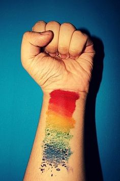 a person's arm with a rainbow colored ink stain on the left side of their arm